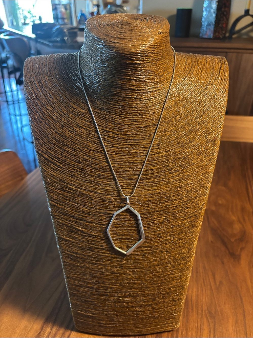 Kendra Scott necklace features a geometric open hexagon pendant